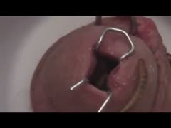 An incredible amateur home film shows a courageous man opening the hole of his schlong.